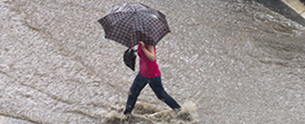 Photo of a woman in heavy rain.
